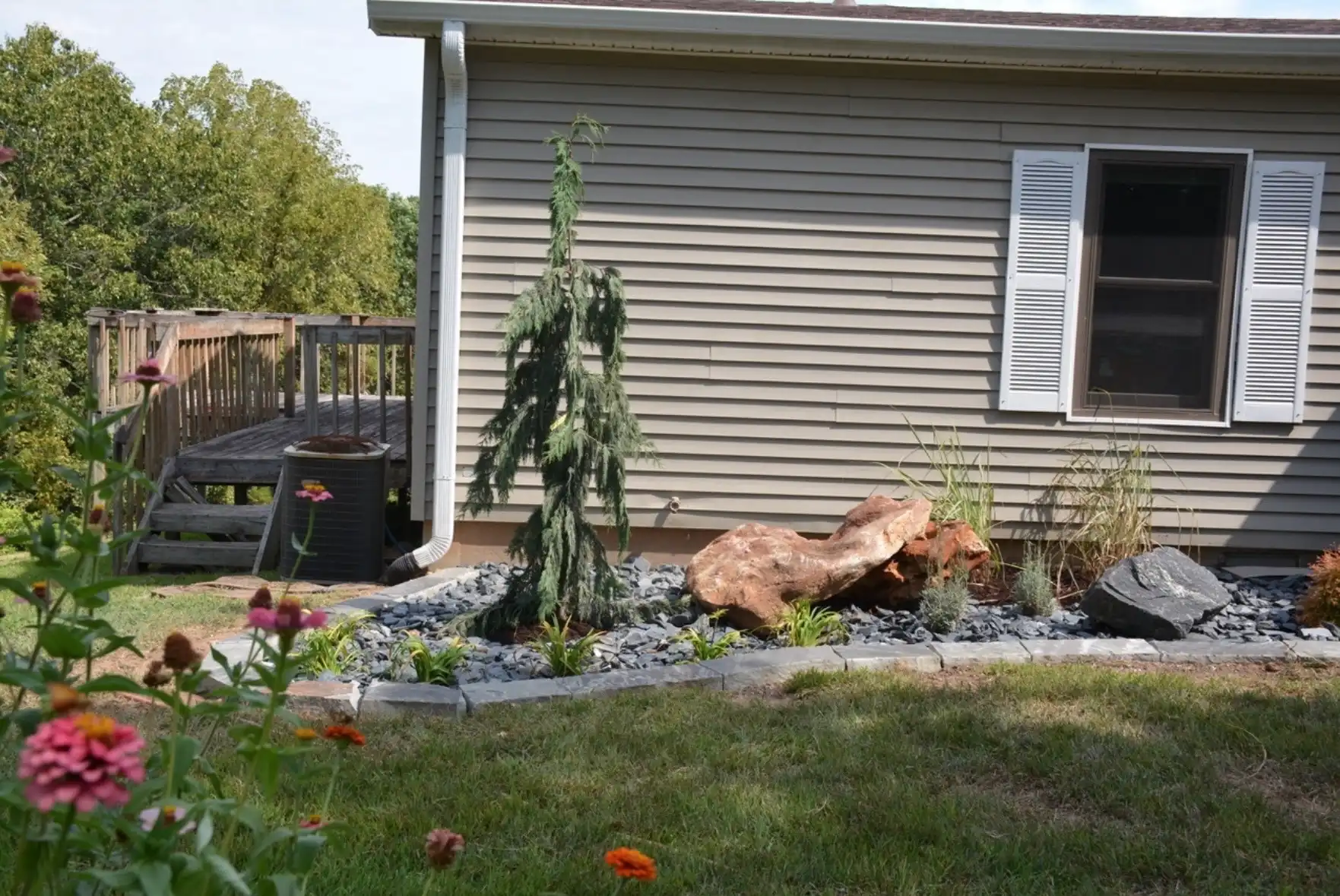 Backyard Boulder & Evergreen Bed